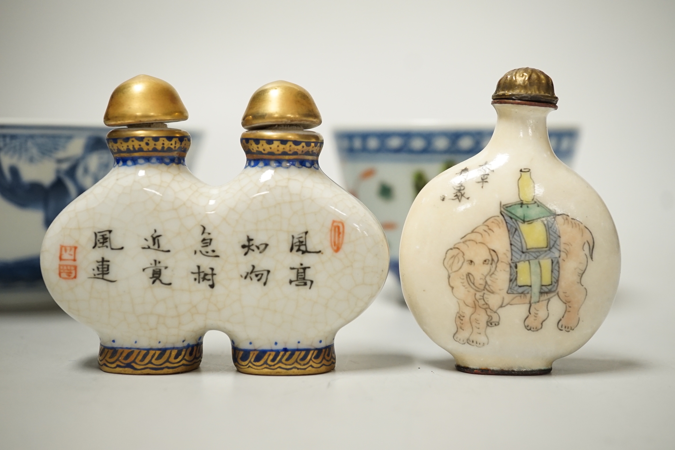 A 19th century Chinese blue and white bowl, an enamelled goldfish cup and two snuff bottles